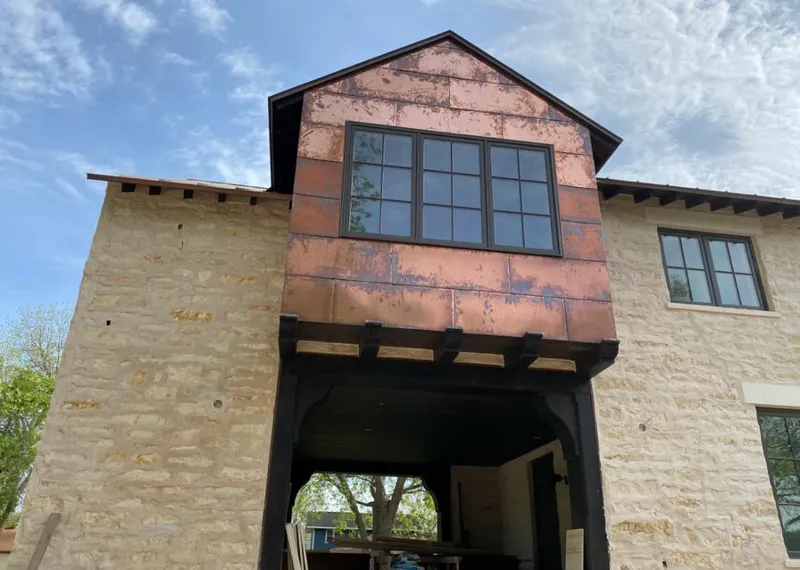 Copper metal panel facade on a stone building for Skylight Installation in Hudsonville